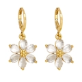 Macro detail of gold flower earrings with six-petal clear crystals and secure lever-back - White