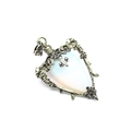 Detail of heart labradorite pendant with opal stone in vintage silver rose frame - Opal