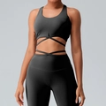 Women's black yoga set featuring cross-strap sports bra and high-waist leggings - Black
