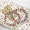 Minimalist synthetic crystal and stone bracelet with pink and blue beads in 45-degree view - Wild Peach Forest Bead Bracelet