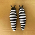 Pair of black and white striped caterpillar sensory fidget toys on cardboard surface - Large Size Black White Slug (18.5cm) (No Box)