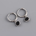 Macro detail of S925 sterling silver hoop earrings with circular black zircon pendant charms - 925 Silver / Black Zirconia (Silver)