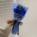 Blauer Seifenrosenstrauß mit drei Blumen und schwarzem Band, als Geschenk in der Hand - Königsblau