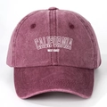 Detailed close-up of washed burgundy cotton baseball cap with white California print - Adjustable / Burgundy