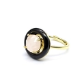 Detailed side view of golden ring featuring a faceted pink gemstone with black halo - Rose Quartz