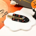 Halloween duckbill hair clip with pumpkin and bat motifs on a white cloud tray - Black Pumpkin Spider Web