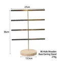 Detail of a 4-tier golden metal jewelry stand with 96 holes and a round wooden base - 96 Holes Gold Metal Rack with Wood Base