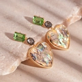 Close-up of vintage heart earrings with green crystals and iridescent abalone shell detail - Green Acrylic Heart Earrings with Silver Pin