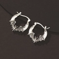 Macro detail of gothic bat earrings in vintage silver finish with textured wings - Antique Silver