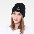 Detailed close-up of white good vibes embroidery on black knitted beanie cuff - Black