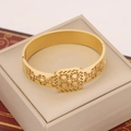 Detail of a hollowed golden sunflower bracelet placed on a cream leather jewelry box - Geometric Sun Pattern Hollow Style (4#)