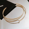 Detail of twisted gold metal collar with ivory resin inlay on a mirrored background - Choker-Gold-Rice White