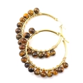 Detail of tiger eye stones wrapped on gold stainless steel hoop earrings - Gold + Tiger Eye
