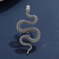 Macro shot of silver punk snake ring showing vintage scale texture on blue surface - Antique Silver Ring