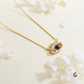 Close-up of gold-plated evil eye pendant with zircon inlay and sun-shaped details - Dark Pupil - Gold Box Chain