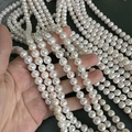 Strand of 7mm creamy white natural freshwater pearls with lustrous near-round finish - 8-9