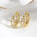 Close-up of 18k gold plated hoop earrings with micro-pave square zircon details - Gold