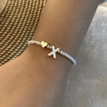 White crystal beaded bracelet with golden heart and letter X shell pendant detail - Letter X