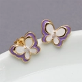 Elegant gold butterfly earrings with purple enamel detailing and sparkling center crystal - Purple