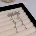 Silver bow tassel drop earrings with sparkling rhinestones in a white jewelry box - Full Rhinestone Bowknot Wave Tassel (HSLE5131 Silver)
