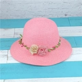 Detail of pink straw sun hat featuring decorative fabric flowers and green leaf vines - M (56-58cm) / Pink