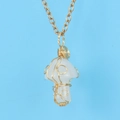 Macro shot of gold wire-wrapped opal mushroom pendant on a thin gold chain - White Crystal