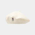 Detail shot of ivory white beret featuring two marble textured decorative buttons - One Size / White