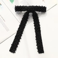 Close-up of elegant black beaded bow hair clip with textured pearls on a minimalist background - Black Pearl Beaded Bow Clip