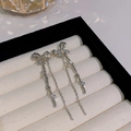 Elegant silver bow tassel earrings with sparkling white zircons on a display stand - Bowknot Zirconia Fine Chain Tassel (HSLA1239 Silver)