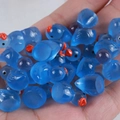 Mini blue luminous resin ducks for DIY crafts shown being held in a person's hand - Dark Blue