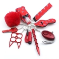 Macro shot of red neoprene personal safety keychain kit with plush ball and wristlet strap - Red/Black Plaid