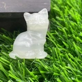Cute 1.2-inch hand-carved clear natural crystal cat figurine on green grass - Afghan Jade