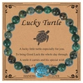 Handmade beaded bracelet with turquoise stones and blue turtle pendant on card - African Pine Stone