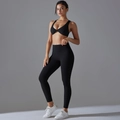 Detail of high-elastic black yoga set featuring twist-front bra and high-waist leggings - S / Black