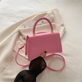 Pink quilted shoulder bag with gold heart embroidery and braided top handle - Pink