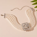 Detailed macro view of a 5-strand pearl necklace with a large crystal centerpiece - Silver Rhinestone Multi-Layer Pearl Necklace