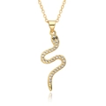 Close-up of gold snake pendant with sparkling crystals and black stone eyes - D522-White & Black Zirconia Snake
