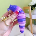 Flexible purple articulated slug fidget toy keychain with a golden bell and key ring - Caterpillar - Purple