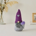 Purple knitted gnome plush with grey heart patch holding a small bouquet of silk flowers - Lavender Purple Male
