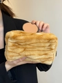 Plush makeup bag with orange and white tiger stripes held by a model for travel - Plush Brown Zebra Print