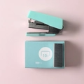 Detailed top view of mint green mini stapler with a box of 10-size staples on pink background - Mint Green