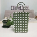 Detail of green and white checkered woven bucket bag showing its texture and sturdy handle - Large / Green and White