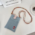 Close-up of apple embroidery and pink plaid flap on light blue denim mini crossbody bag - Light Blue Apple