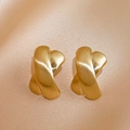 Macro shot of matte gold X-shaped cross earrings with brushed metal texture on silk - Silver Pin - Gold X-Shape Studs / Gold