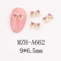 Macro view of gold bow nail charms with pink rhinestones and 9x6.5mm size details - Spreading Wing Bow (A662)