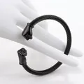 Close-up of black twisted cable cuff bracelet featuring detailed double fist end caps - Black