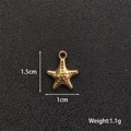 Macro detail of a 1.5cm golden starfish pendant showing precise size and weight parameters - Starfish 1
