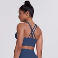Detail of cross-back straps on navy blue sports bra with brushed fabric texture - Navy Blue