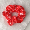 Macro detail of red satin Christmas scrunchie with white snowflakes and tree patterns - Style 5 (Red Snowflake Tree)