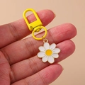 Cute white daisy flower keychain with yellow enamel heart and gold metal clasp - Flower